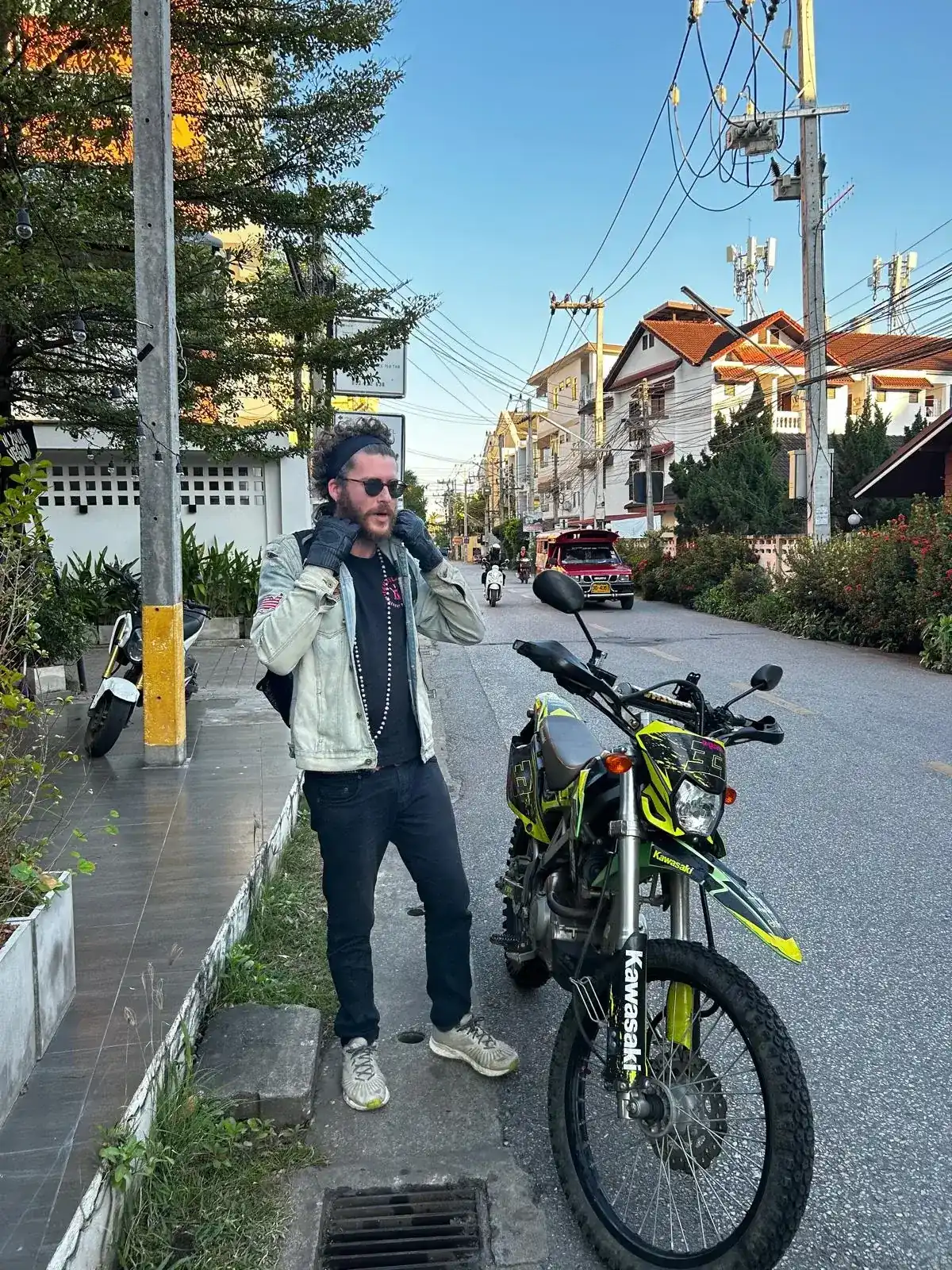 AJ sitting on a motorbike in Chiang Mai