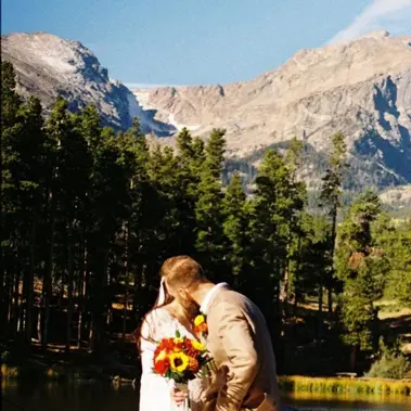 Couple walking hand in hand along a lakeside path