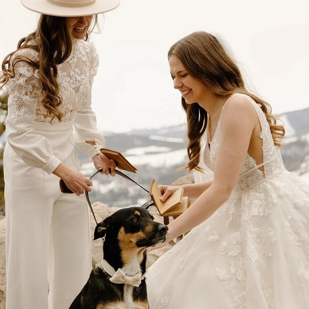 Just-married couple smiling with their officiant