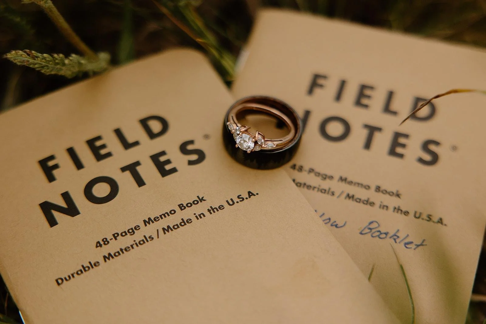Close-up of wedding rings resting on a vibrant flower bouquet