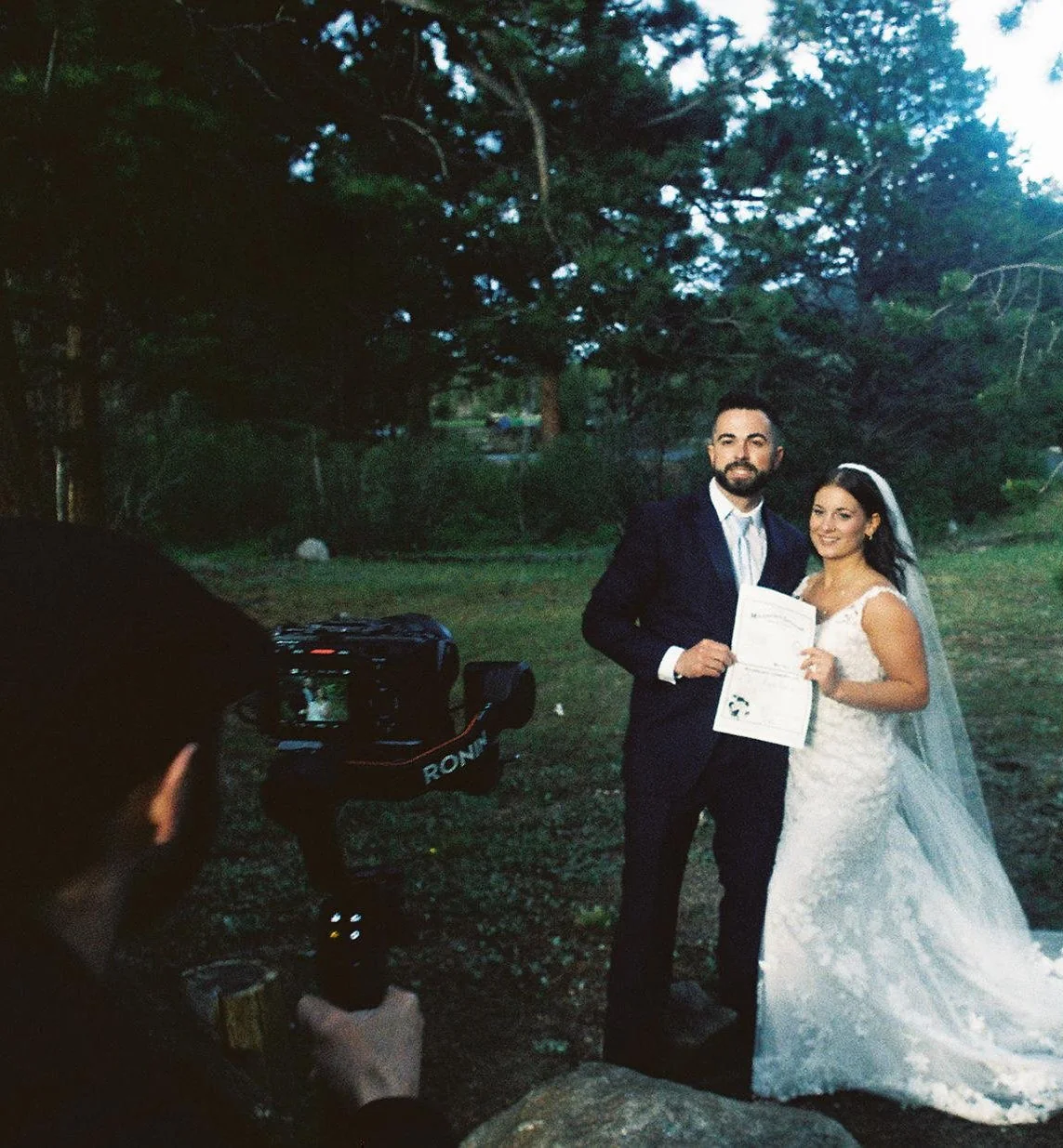 Two brides with their dog during a mountain wedding ceremony